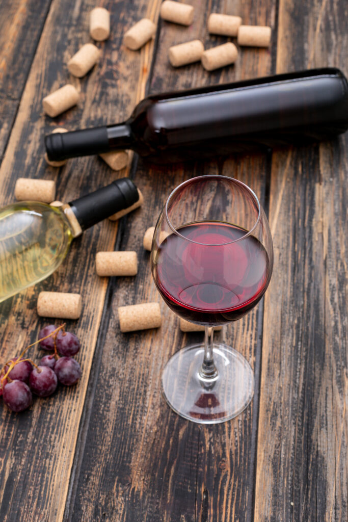 side-view-wine-bottles-with-glass-dark-wooden-vertical-683x1024.jpg