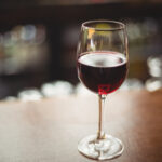 Close-up of glass with red wine on table at bar