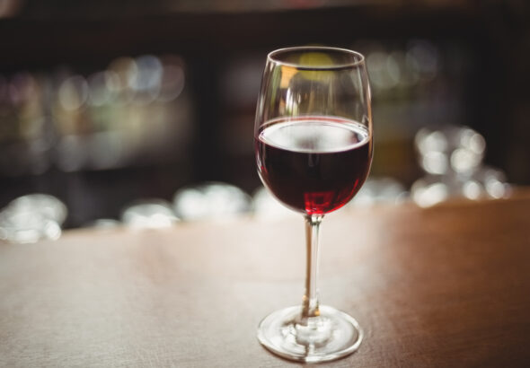 Close-up of glass with red wine on table at bar