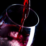 Pouring red wine into the glass
