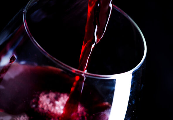 Pouring red wine into the glass
