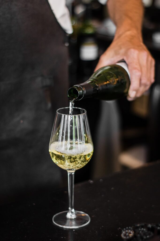 vertical-shot-bartender-pouring-wine-glass-2-682x1024.jpg