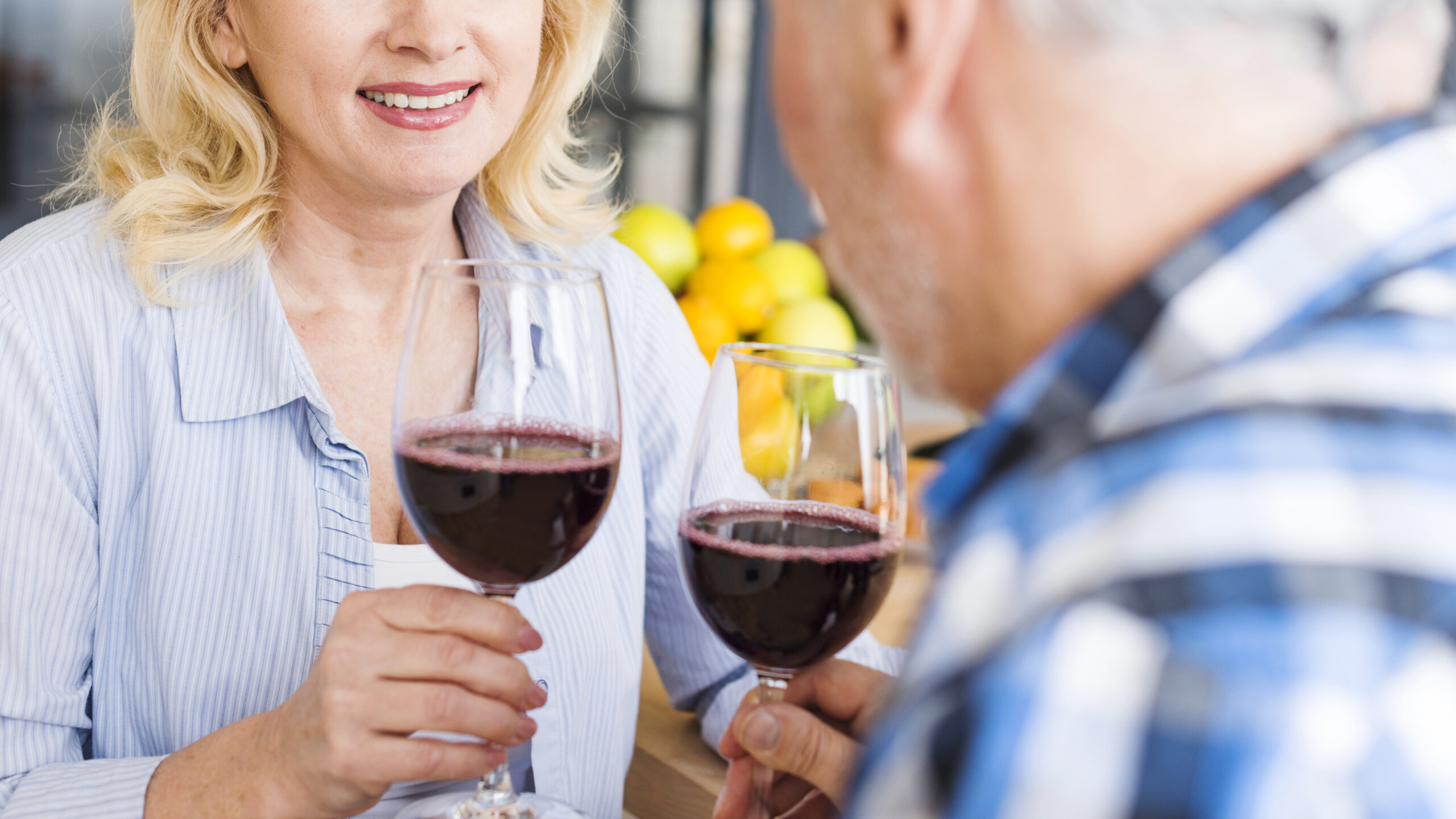 close-up-couple-holding-wineglasses-hand-scaled-jpg