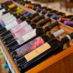 colorful wine bottles displayed on wooden rack