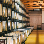 Wood wine barrels stored in a winery on the fermentation process